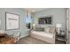 Bright bedroom features a daybed with pillows and a desk near a window, creating a cozy and functional space at 1797 Trailhead Ln, Zephyrhills, FL 33541