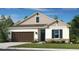 Charming single-story home with a well-manicured lawn, neutral palette, and a welcoming two-car garage at 1797 Trailhead Ln, Zephyrhills, FL 33541