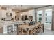 Bright kitchen with an island, white cabinets, and stainless steel appliances, adjacent to the dining area at 1797 Trailhead Ln, Zephyrhills, FL 33541