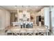 Open-concept kitchen and dining area featuring pendant lighting, island seating, and stainless-steel appliances at 1797 Trailhead Ln, Zephyrhills, FL 33541