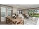 Open-concept living and dining area with comfortable seating, a modern rug, and plenty of natural light at 1797 Trailhead Ln, Zephyrhills, FL 33541