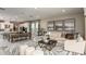 Inviting living room adjacent to a dining area and kitchen, perfect for entertaining guests at 1797 Trailhead Ln, Zephyrhills, FL 33541