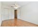 Bright bedroom features hardwood floors, a ceiling fan, and closet at 18502 Keystone Manor Rd, Odessa, FL 33556