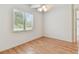 Bright bedroom with hardwood floors, a window, and white trim at 18502 Keystone Manor Rd, Odessa, FL 33556