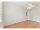 Bright bedroom features hardwood floors, a ceiling fan, and a closet at 18502 Keystone Manor Rd, Odessa, FL 33556