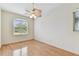 Bright bedroom with vaulted ceiling, hardwood floors, and a large window at 18502 Keystone Manor Rd, Odessa, FL 33556