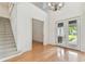 Inviting foyer with soaring ceilings, staircase, chandelier, and glass-paneled entry doors at 18502 Keystone Manor Rd, Odessa, FL 33556