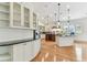 Gourmet kitchen with white cabinets, hardwood floors, stainless steel appliances, and a large island at 18502 Keystone Manor Rd, Odessa, FL 33556