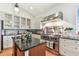 Chef's kitchen with stainless steel appliances, granite countertops, and custom cabinetry at 18502 Keystone Manor Rd, Odessa, FL 33556
