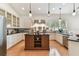 Bright kitchen features a center island, stainless appliances and granite countertops at 18502 Keystone Manor Rd, Odessa, FL 33556