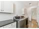 Convenient laundry room with modern washer and dryer, plus cabinetry for storage at 18502 Keystone Manor Rd, Odessa, FL 33556