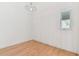 Minimalist living room with wood floors, ample natural light and modern lighting fixture at 18502 Keystone Manor Rd, Odessa, FL 33556