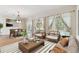 Bright living area with hardwood flooring, comfortable seating, and view of the outdoor pool at 18502 Keystone Manor Rd, Odessa, FL 33556