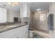 Bathroom featuring granite countertop and glass enclosed shower at 223 Island Way # 2C, Clearwater Beach, FL 33767