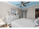 Bright bedroom features a stylish dresser and a ceiling fan at 223 Island Way # 2C, Clearwater Beach, FL 33767