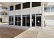 Exterior view of a building entrance with large windows and glass doors, offering a welcoming and modern facade at 223 Island Way # 2C, Clearwater Beach, FL 33767