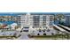 Multi-story condo building with private parking and waterfront views on a sunny day at 223 Island Way # 2C, Clearwater Beach, FL 33767