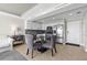Modern kitchen adjacent to a dining area, featuring stainless steel appliances and sleek white cabinetry at 223 Island Way # 2C, Clearwater Beach, FL 33767