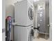 Laundry room with a stackable washer and dryer and mechanical equipment at 223 Island Way # 2C, Clearwater Beach, FL 33767