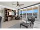 Bright living room featuring a large entertainment center and sliding glass doors leading to a balcony at 223 Island Way # 2C, Clearwater Beach, FL 33767