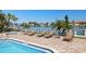 Relaxing outdoor space featuring a pool, spa, lounge chairs, and waterfront views with boat docks at 223 Island Way # 2C, Clearwater Beach, FL 33767