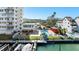 Community amenities featuring a waterfront pool, docks, and nicely landscaped grounds at 223 Island Way # 2C, Clearwater Beach, FL 33767