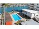 Waterfront community pool with lounge chairs, docks, and beautiful water views at 223 Island Way # 2C, Clearwater Beach, FL 33767