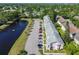 An aerial view captures the condo community's layout with convenient parking and peaceful pond setting at 2291 Americus W Blvd # 23, Clearwater, FL 33763