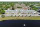 Aerial view shows a well-manicured condo community with pond, palm trees, and convenient parking at 2291 Americus W Blvd # 23, Clearwater, FL 33763