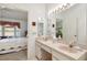Bathroom showcasing a double vanity, tile floors, and a glimpse of the bedroom at 2291 Americus W Blvd # 23, Clearwater, FL 33763