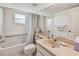 Bright bathroom with a combined shower and tub and a large mirror at 2291 Americus W Blvd # 23, Clearwater, FL 33763