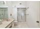 Bright bathroom with a walk-in shower with glass doors, a toilet and vanity at 2291 Americus W Blvd # 23, Clearwater, FL 33763