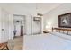 Cozy bedroom featuring an open closet and a wooden bed frame at 2291 Americus W Blvd # 23, Clearwater, FL 33763