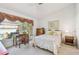 Bright bedroom featuring a decorative window, desk, and a comfortable bed at 2291 Americus W Blvd # 23, Clearwater, FL 33763