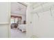A bedroom view showing a ceiling fan, neutral carpet and curtains, and wire shelving in the closet at 2291 Americus W Blvd # 23, Clearwater, FL 33763