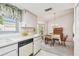 Combined kitchen and dining area featuring modern appliances and a cozy dining set at 2291 Americus W Blvd # 23, Clearwater, FL 33763