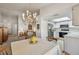 Open-concept view showcasing dining area with chandelier, adjacent to the living room and kitchen at 2291 Americus W Blvd # 23, Clearwater, FL 33763