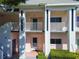 The exterior of this two-story condo shows well-kept landscaping, balconies, and access to stairs at 2291 Americus W Blvd # 23, Clearwater, FL 33763