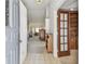 Inviting foyer featuring tile flooring that flows into a carpeted living space and wooden accents at 2291 Americus W Blvd # 23, Clearwater, FL 33763