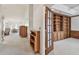 Inviting foyer leading into a carpeted living space featuring wooden accents and plenty of natural light at 2291 Americus W Blvd # 23, Clearwater, FL 33763