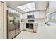 Updated kitchen with stainless steel appliances and white cabinets, providing a modern aesthetic at 2291 Americus W Blvd # 23, Clearwater, FL 33763
