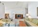 A cozy living room with plush, patterned furniture, a ceiling fan, and an open view to an adjacent room at 2291 Americus W Blvd # 23, Clearwater, FL 33763