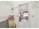 Walk-in closet showing shelving, a clothes rack, and a glimpse into the adjacent bedroom at 2291 Americus W Blvd # 23, Clearwater, FL 33763