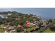 Aerial view of waterfront homes with private docks on a canal leading to the bay, surrounded by lush greenery at 3334 Pineview Dr, Holiday, FL 34691