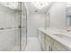 Bright bathroom features marble floors, a glass shower, and double vanity sinks at 3334 Pineview Dr, Holiday, FL 34691