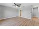 Neutral bedroom with a ceiling fan and wood-look floors at 3334 Pineview Dr, Holiday, FL 34691
