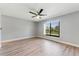 Sunlit bedroom showcases a neutral palette and wood-look floors at 3334 Pineview Dr, Holiday, FL 34691