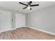 Neutral bedroom with a ceiling fan and wood-look floors at 3334 Pineview Dr, Holiday, FL 34691