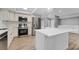 Renovated kitchen with stainless steel appliances and a large center island, creating an open and inviting space at 3334 Pineview Dr, Holiday, FL 34691