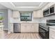 Bright kitchen with updated appliances, white cabinets, quartz countertops, and tile backsplash at 3334 Pineview Dr, Holiday, FL 34691
